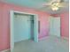 Bedroom closet with double doors and hanging rods at 1535 Council Dr, Sun City Center, FL 33573