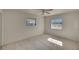 Bright bedroom with ceiling fan and carpeted floor at 1535 Council Dr, Sun City Center, FL 33573