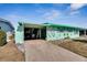 Mint green house with carport and well-maintained lawn at 1535 Council Dr, Sun City Center, FL 33573