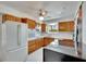 Bright kitchen with wood cabinets, white appliances, and a breakfast nook at 1535 Council Dr, Sun City Center, FL 33573