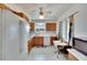 View of kitchen with wood cabinets, white appliances, and a small table at 1535 Council Dr, Sun City Center, FL 33573