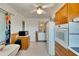Kitchen features wood cabinets, white appliances, and a breakfast nook at 1535 Council Dr, Sun City Center, FL 33573