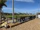 Outdoor lawn bowling green with benches at 1535 Council Dr, Sun City Center, FL 33573