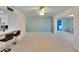 Living room with a ceiling fan, light walls, and access to laundry at 1535 Council Dr, Sun City Center, FL 33573