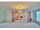 Spacious living room featuring a decorative backdrop and chandelier at 1535 Council Dr, Sun City Center, FL 33573