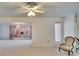 Spacious living room with a ceiling fan and view to another room at 1535 Council Dr, Sun City Center, FL 33573