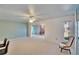 Living room with light walls, ceiling fan, and a view to kitchen at 1535 Council Dr, Sun City Center, FL 33573