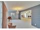 Open living room with gray accent wall and view to kitchen at 1535 Council Dr, Sun City Center, FL 33573