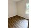 Simple bedroom with grey wood-look flooring and a window at 1714 2Nd E Ave, Bradenton, FL 34208