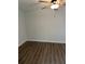 Bright bedroom with ceiling fan and grey wood-look flooring at 1714 2Nd E Ave, Bradenton, FL 34208