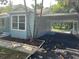 Light blue house with carport, mature trees, and a well-maintained yard at 1714 2Nd E Ave, Bradenton, FL 34208