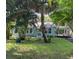 Charming light blue house with lush landscaping and a spacious front yard at 1714 2Nd E Ave, Bradenton, FL 34208
