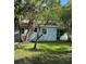 Rear view of a light blue house, surrounded by lush greenery at 1714 2Nd E Ave, Bradenton, FL 34208