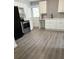 Bright kitchen with stainless steel appliances and grey wood-look flooring at 1714 2Nd E Ave, Bradenton, FL 34208