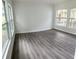 Sunlit living room with large windows and grey wood-look flooring at 1714 2Nd E Ave, Bradenton, FL 34208