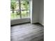 Bright living room with large windows and grey vinyl flooring at 1714 2Nd E Ave, Bradenton, FL 34208