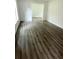 Open living space with grey wood-look flooring and views into another room at 1714 2Nd E Ave, Bradenton, FL 34208