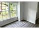 Bright living room with large windows and grey wood-look flooring at 1714 2Nd E Ave, Bradenton, FL 34208