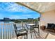Balcony with water view and seating area at 19811 Gulf Blvd # 102, Indian Shores, FL 33785