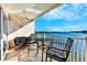 Spacious balcony with water views, table and chairs, and seating area at 19811 Gulf Blvd # 102, Indian Shores, FL 33785