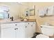 Bathroom with toilet, vanity, and white cabinets at 19811 Gulf Blvd # 102, Indian Shores, FL 33785