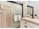 Clean bathroom with a shower, vanity, and white cabinetry at 19811 Gulf Blvd # 102, Indian Shores, FL 33785