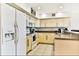 Bright kitchen featuring white appliances and light wood cabinets at 19811 Gulf Blvd # 102, Indian Shores, FL 33785