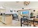 Open kitchen with breakfast bar, white cabinets, and stainless steel appliances at 19811 Gulf Blvd # 102, Indian Shores, FL 33785