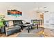 Living room with leather sectional and large artwork at 19811 Gulf Blvd # 102, Indian Shores, FL 33785
