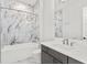 Clean bathroom with marble tile and a bathtub at 2926 Coffee Pot Ne Blvd, St Petersburg, FL 33704