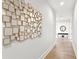 Light-filled hallway with modern mirror and hardwood floors at 2926 Coffee Pot Ne Blvd, St Petersburg, FL 33704