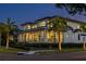 Stunning two-story home with a modern design at dusk at 2926 Coffee Pot Ne Blvd, St Petersburg, FL 33704