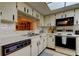 View into kitchen with updated appliances and cabinets at 3055 Casa Del Sol Cir # 303, Clearwater, FL 33761