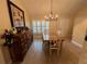 Bright dining room with hardwood floors, chandelier, and built-in hutch at 3638 Trafalgar Way # 102, Palm Harbor, FL 34685