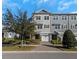 Modern 3-story townhome with gray siding, white trim, and a 2-car garage at 4069 Rocky Shores Dr, Tampa, FL 33634