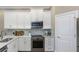 Modern kitchen with stainless steel appliances and white cabinetry at 4069 Rocky Shores Dr, Tampa, FL 33634