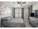 Well lit bedroom with neutral paint, ceiling fan, and large window at 4221 W Spruce St # 2418, Tampa, FL 33607