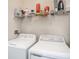 Laundry room with washer, dryer, and overhead shelving at 4221 W Spruce St # 2418, Tampa, FL 33607