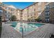 Community pool with lounge chairs and surrounding building at 4221 W Spruce St # 2418, Tampa, FL 33607