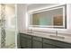 Modern bathroom with double vanity, illuminated mirror, and glass shower at 479 Winwood Ct, Port Charlotte, FL 33954