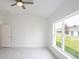 Spacious bedroom with large window and ceiling fan at 479 Winwood Ct, Port Charlotte, FL 33954