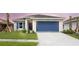 One-story home with blue garage door and landscaping at 479 Winwood Ct, Port Charlotte, FL 33954