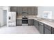 Modern kitchen with gray cabinets and stainless steel appliances at 479 Winwood Ct, Port Charlotte, FL 33954