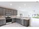 Modern kitchen with gray cabinets and stainless steel appliances at 479 Winwood Ct, Port Charlotte, FL 33954