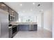 Modern kitchen with gray cabinets and stainless steel appliances at 479 Winwood Ct, Port Charlotte, FL 33954