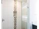Glass shower with pebble tile accents and built-in shelving at 479 Winwood Ct, Port Charlotte, FL 33954