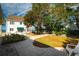 Landscaped backyard with stone patio and walkway at 55 Edgewater Dr, Dunedin, FL 34698