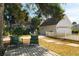 Relaxing backyard patio with seating area and lush landscaping at 55 Edgewater Dr, Dunedin, FL 34698