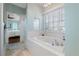Bathroom with large soaking tub and marble floors at 55 Edgewater Dr, Dunedin, FL 34698