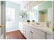 Double vanity bathroom with white cabinets and a modern design at 55 Edgewater Dr, Dunedin, FL 34698